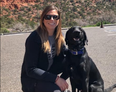 Crime victims, witnesses, and first responders in the city of Pinole, CA, will now have access to a 70-pound black Labrador retriever—named Milo—to help them with emotional support. Here, Milo is training with his handler, Pinole Police Officer Jennifer Witschi. (Photo: Pinole PD)