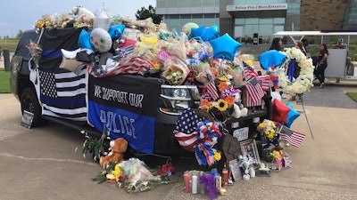 Hundreds of citizens joined officers with the Grand Prairie Police Department at a candlelight vigil Sunday night in honor of Officer Albert Castaneda, who was struck and killed by a car while standing outside of his patrol vehicle running radar on the President George Bush Turnpike.