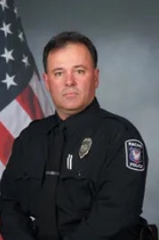 Officer John Hetland was attempting to stop the robbery when the suspected offender opened fire, fatally wounding him.