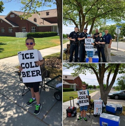 A Utah boy eschewed the idea of operating a traditional summertime lemonade stand and instead opened on the sidewalk a stand selling 'Ice Cold Beer,' according to the sign he held while standing beside a number of coolers.