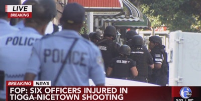 Philadelphia officers outside a home where a standoff is under way. Six officers have been shot. The wounds are reportedly non-life threatening. (Photo: ABC 6 Screen Shot from Live Coverage)
