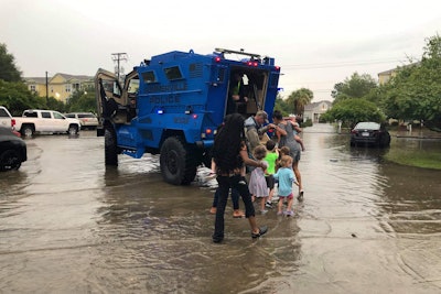 Officers with the Summerville (SC) Police Department saw that there was an imminent danger for kids at a local daycare facility attempting to get to their parents through street flooded with rainwater.