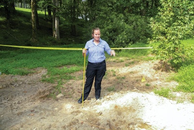 Forensic anthropologist Dr. Meredith Tise from the Pinellas County (FL) Sheriff's Office demonstrated how investigators use a metal probe to examine loose ground at a suspicious grave site.