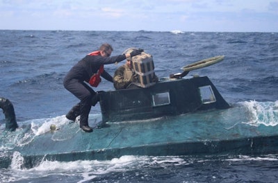 Coast Guard personnel removes cocainse bundles from a captured submarine. (Photo: Coast Guard)