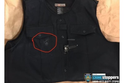 A photo of a vest with a bullet hole circled. The vest is believed to have saved the life of the NYPD officer who was wearing it.