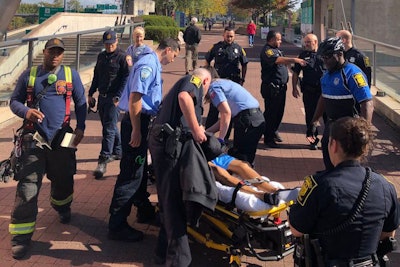 Officer Jimmy Barrett, to the right in bicycle uniform, grabbed a suicidal subject as he was attempting to jump off a ledge to the busy street below.