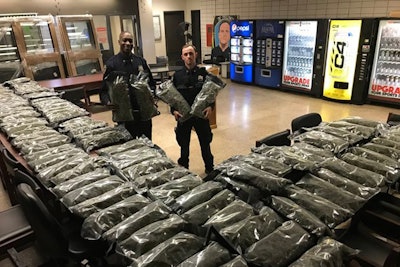 The New York Police Department posted an image on social media of two officers holding what appear to be giant bags of marijuana along with two tables covered in similar bags. However, the haul was legally-grown hemp, not marijuana.