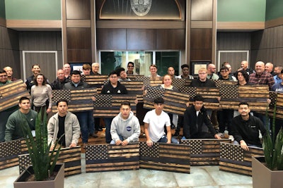 Students attending Waxahachie High School presented 98 handmade wooden 'Thin Blue Line' flags to their local police department in a show of respect for the officers who work there and solidarity with the department.