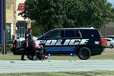 Officer Chris Douglas saw a woman attempting to cross the busy intersection and decided to stop his vehicle in the roadway to block traffic.