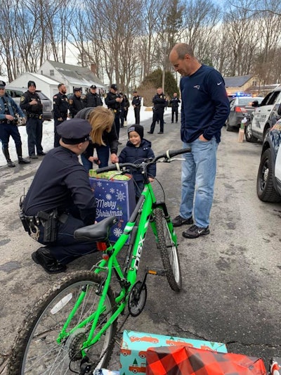 Officers from 10 police departments around the state, plus Massachusetts State Police, surprised 4-year-old JJ Clifford with Christmas gifts. (Photo: Facebook)