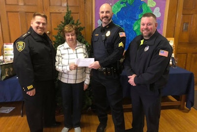 Deputy Chief of Police David Clark, Reading Food Pantry Coordinator Phyllis Maxwell, Sergeant Chris Jones, and Officer Mike Scouten celebrate the holidays with a generous donation to families in need.