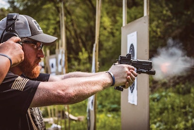 Police trainer Jim Dexter of the Lisle (IL) Police Department demonstrates the proper technique for shooting a pistol outfitted with red dot optics.