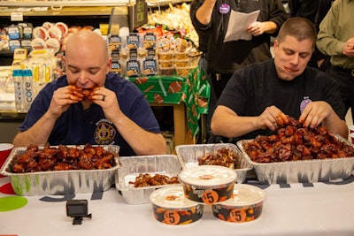 Manchester Fire Lieutenant Matt LeRoux (left) and Manchester Police Officer Ricardo Tavares (right) each had before them a 22-pound pile of bone-in wings and five minutes to do as much damage as they could.