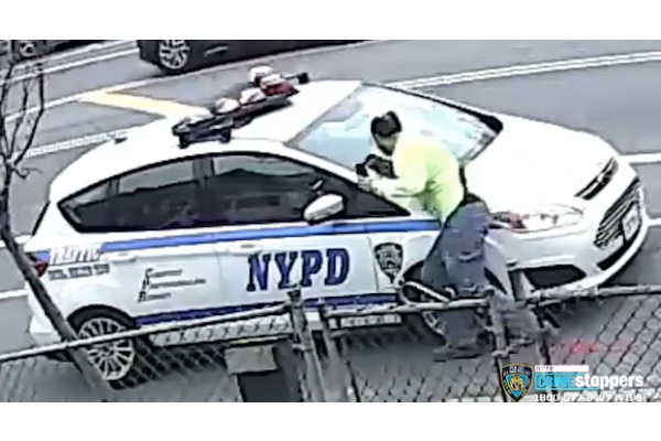 A man is caught on video attacking a parked NYPD vehicle.