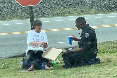 A Goldsboro (NC) Police Department officer shares a pizza lunch with a homeless woman.
