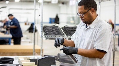 Ford worker assembles a face shield. (Photo: Ford)