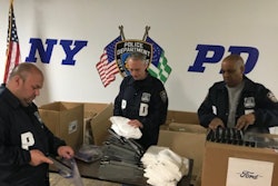 NYPD officer open a shipment of coronavirus face shields from Ford. (Photo: Ford)