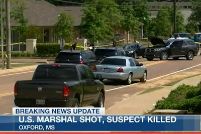 A US Marshal was shot twice in a gunfight with a murder suspect from Arkansas following a vehicle pursuit.