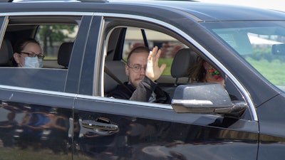Wounded San Marcos, TX, police officer Justin Mueller waves to supporters as he leaves the hospital. (Photo: San Marcos PD)