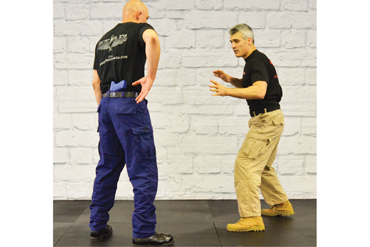 Standing close to the suspect and with your sidearm holstered you see him start to draw.