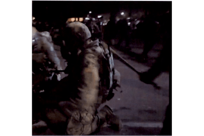 Screen grab from live video shows U.S. Marshal being struck with a bat during July 27 riot.