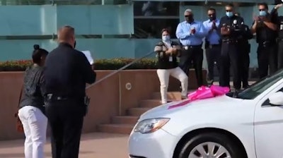 This woman's car was destroyed by gang members. Officers from the LAPD's Hollenbeck Division partnered with police organizations and a local business to get her a new one. (Photo: LAPD/Twitter)