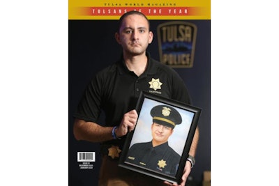 Cover photo of the Tulsa World magazine shows Officer Aurash Zarkeshan holding a portrait of his slain supervisor Sgt. Craig Johnson. Both men have been honored as Tulsans of the year. (Photo: Tulsa World)