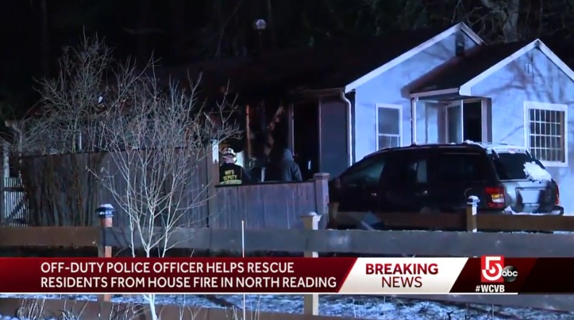An off-duty North Reading, MA, officer saw this house on fire and had to kick in the door to alert the residents. (Photo: WCVB screen shot)