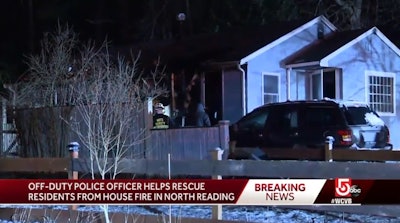 An off-duty North Reading, MA, officer saw this house on fire and had to kick in the door to alert the residents. (Photo: WCVB screen shot)