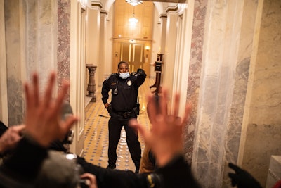 Capitol Police Officer Eugene Goodman delayed the mob and led them away from the Senate chambers. (Photo: Twitter Video)