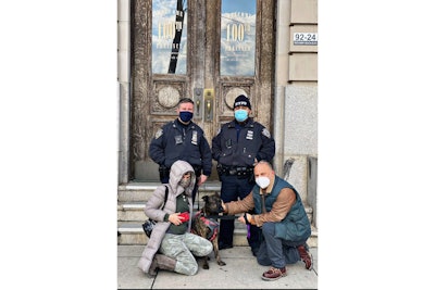 Members of the NYPD Harbor team that rescued Tinkerbell pose with the dog and his owners. (Photo: NYPD)
