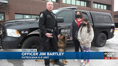 Officer Jim Brantley with 11-year-old Izzy Greenfelder, her mother Brandi, and K-9 Max in his new body armor. (Photo: News 6 Screen Shot)