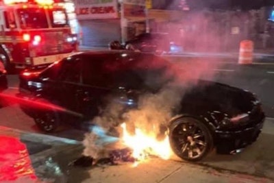 An NYPD officer's personal vehicle burns outside of a Coney Island subway station. (Photo: PBA)