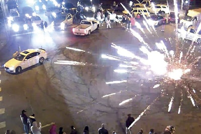 Fireworks are set off in the middle of a blocked off intersection that was the scene of a dangerous “sideshow.” Aurora, CO, officers responded to this crime scene as part of the city’s efforts to interdict street racing and the hazards to the community that it presents. Street racing events often result in injuries to drivers, spectators, and uninvolved members of the public. (Photo: Aurora PD)