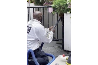 An NYPD beekeeper sucks up bees in Times Square. (Photo: NYPD/Twitter)