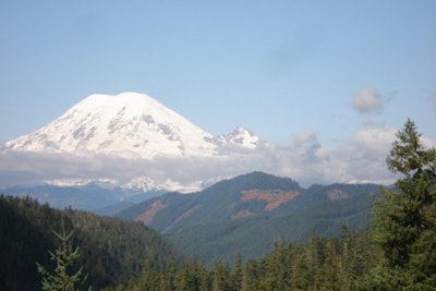Mount Rainier is the tallest volcanic mountain in the contiguous United States, and due to the ever-increasing prospect of an eruption, it is considered one of the most dangerous volcanoes on the planet. Reaching its summit—and getting back down—is an appropriate metaphor for policing in America at the midway point of 2021. (Image courtesy of June Burton Wilson / Facebook)
