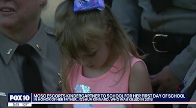 Seven-year-old Juliana Kinnard was escorted to her first day of school Wednesday by deputies of the Maricopa County Sheriff's Office and officers of the Gilbert Police Department. (Photo: Fox 10 screen shot)