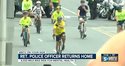 Retired Sergeant Christopher Lowrance arrives home in North Carolina after bicycling from Oregon to raise awareness of police suicide. (Photo: WBTV Screen Shot)