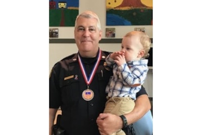 Lt. Alan Lessieur, pictured here with his grandson Asher, was named the Pepperell Police Department’s Officer of the Year in 2018. He was due to retire later this year. (Photo: Pepperell PD)