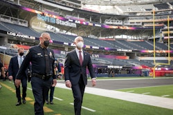 Alejandro Mayorkas, secretary of the Department of Homeland Security, walks along the field at SoFi Stadium with Inglewood Police Chief Mark Fronterotta while working with state and local law enforcement and the National Football League to review DHS operations prior to Super Bowl LVI.