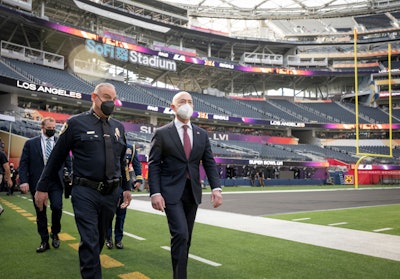Alejandro Mayorkas, secretary of the Department of Homeland Security, walks along the field at SoFi Stadium with Inglewood Police Chief Mark Fronterotta while working with state and local law enforcement and the National Football League to review DHS operations prior to Super Bowl LVI.
