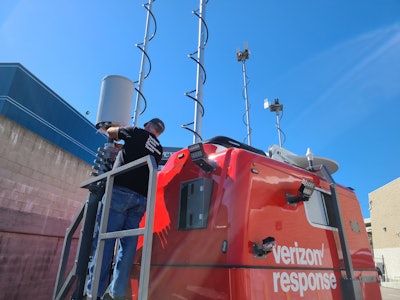 A member of the Verizon Response Team simulates the deployment of a Satellite Picocell on a Trailer (SPOT) outside of the Verizon Network Command Center in Los Angeles. A SPOT is a small mobile cell site with satellite connectivity. It helps keep first responders and others connected during emergency response and recovery efforts.