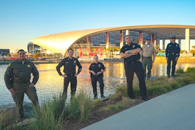 Inglewood Police Lt. Scott Collins, front, is shown outside SoFi Stadium surrounded by representatives of other area agencies that assisted Inglewood with Super Bowl security.