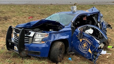 A Michigan State Police trooper had to be cut out of his patrol car Friday after it was hit by a truck. (Photo: MSP)