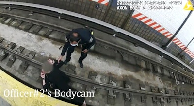 Body-worn video shows the moment a NYPD officer rescues a woman who collapsed and fell onto the subway tracks earlier this week.