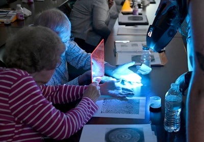 Senior Citizen Police Academy participants learn through a hands-on exercise with the Crime Scene Investigations Unit.