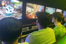 Young people play video games inside the Orange County Sheriff’s Office Mobile Video Game Theater.