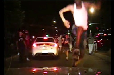 Members of the mob that swarmed an Illinois State Police patrol vehicle are shown rushing toward the trooper before shattering the car’s windshield in Chicago.