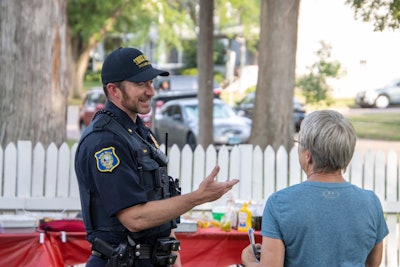 A Sioux Falls, SD, officer connects with a community member Tuesday evening during National Night Out.