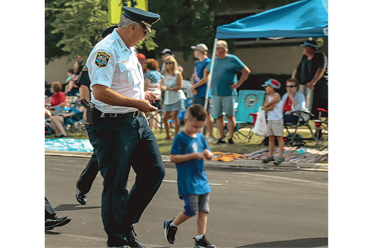 Niles, IL, Police Chief Luis Tigera marches in a local parade with his grandson and eats tacos with his troops. Tigera’s career began in Niles in 1980 when he signed on as a community service officer. It took him to the Illinois State Police and then back to Niles to lead the force. (Photo: Niles PD)